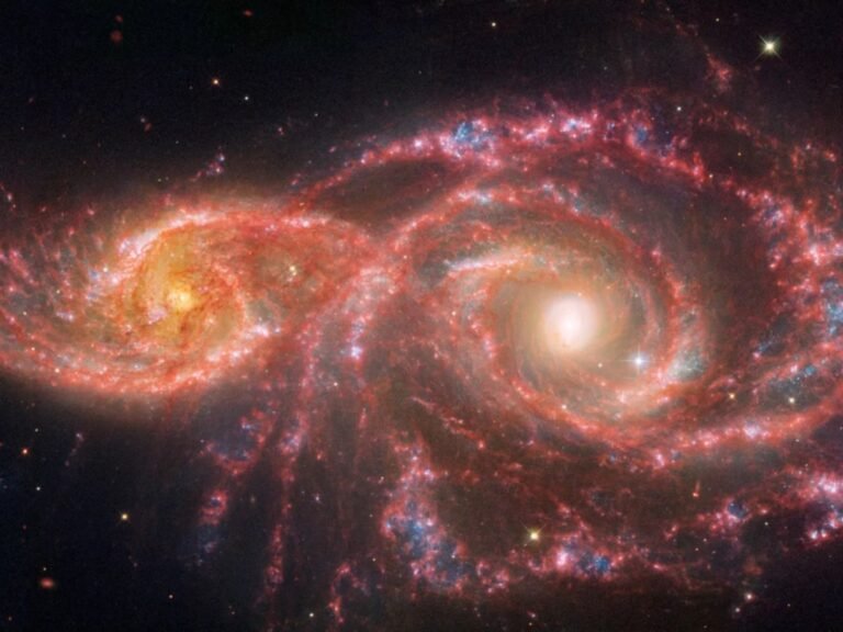 This galaxy sends a destructive ray at another galaxy